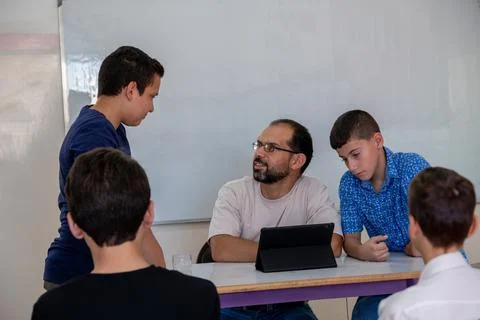 Students communicating with their teacher about there status and achievements Stock Photos