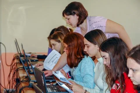 Students in a computer class with a teacher Stock-Fotos