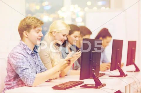 Students with computer monitor and smartphones Stock Photos