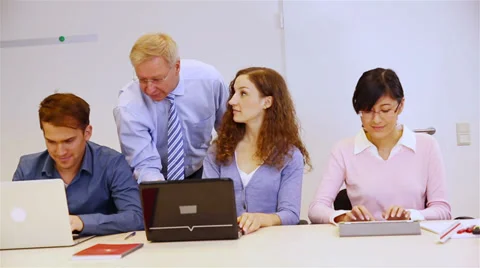 Students with computers and teacher in classroom Stock Footage 32818567