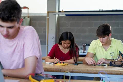 Students concentrated working on their technology class learning to build Stock Photos