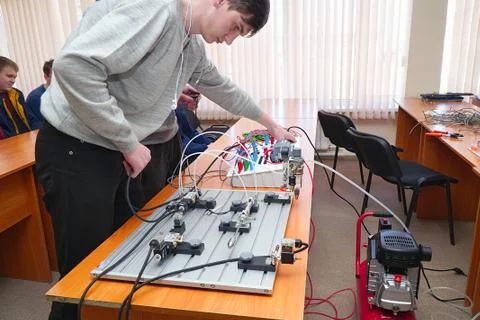Students connect wires control panel with small test bench for experiments Stock Photos