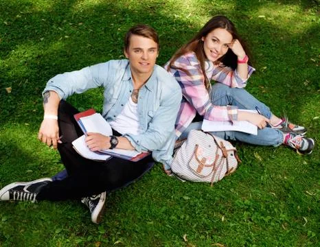 Students couple preparing for final exams in a city park Stock Photos