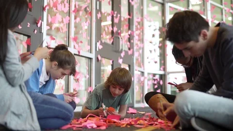 Students decorating their school with butterfly cutouts 動画素材 83399438