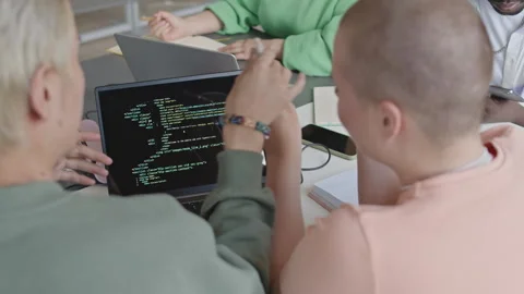 Students Discussing Code on Laptop during Programming Class Stock Footage 257065224