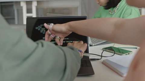 Students Discussing Programming Code on Laptop Screen Stock Footage 257065226