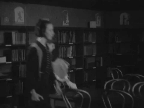 Students do research in a library and create an experiment to study wind. Stock Footage 74875608