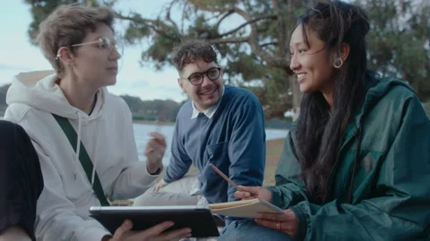 Students Doing College Homework with Digital Tablet in the Park Video stock 237055862