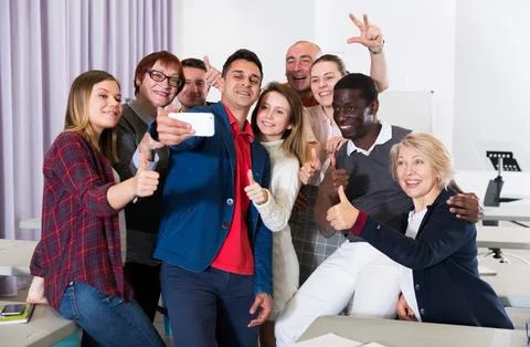 Students doing group selfie Фото