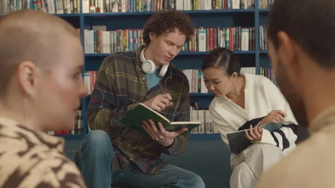 Students Doing Homework and Discussing Problem Solution in Library Stock Footage 263099950