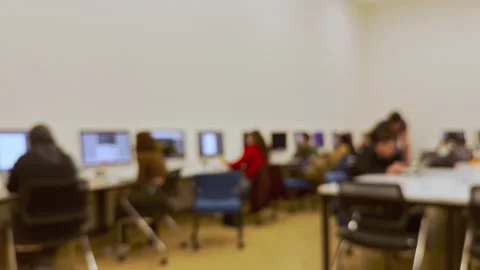 Students doing homework on the computer in class and listening to the Stock Footage 288194763