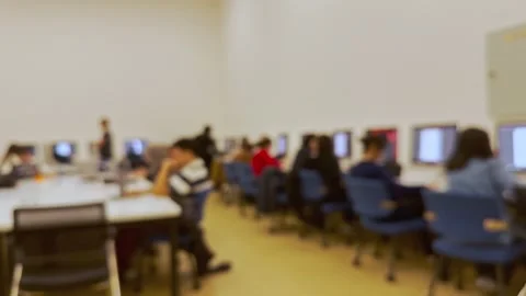 Students doing homework on the computer in class and listening to the Stock Footage 288197889