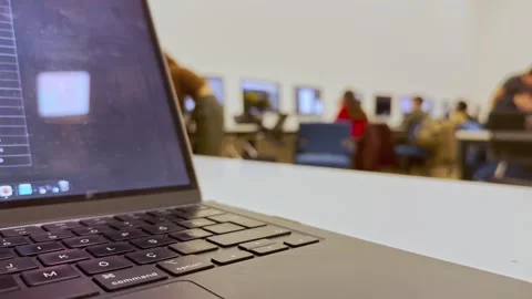 Students doing homework on the computer in class and listening to the Stock Footage 288198221