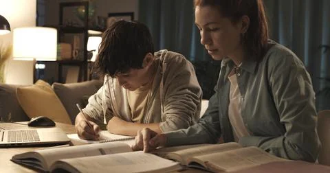 Students doing homework at home Stock Photos