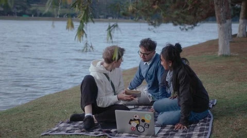 Students Doing Homework with Laptop in the Park Video stock 237055706