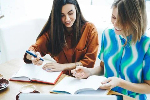 Students doing homework together in cafe Stock Photos