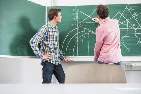 Students doing math equation on board Foto stock