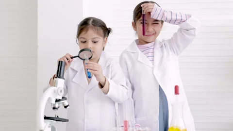 Students doing research with chemical fluid in laboratory, elementary schoo.. Stock Footage 243640063