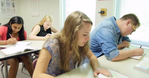 Students doing their assignments/homework in class. Ultra HD 4K Stock Footage 44874787