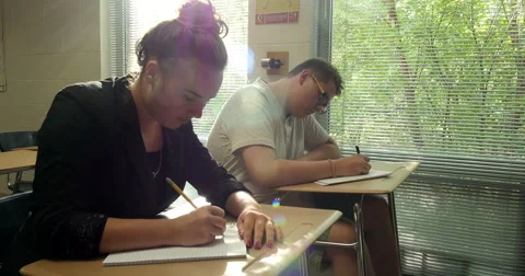 Students doing their school assignments and homework in class. Ultra HD 4K Stock Footage 45572849