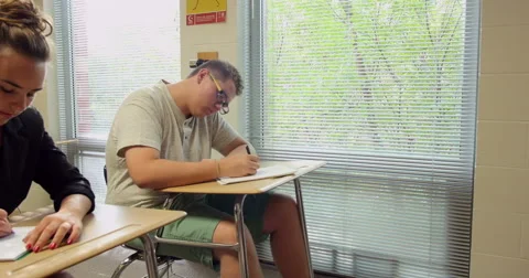 Students doing their school assignments and homework in class. Ultra HD 4K Stock Footage 45572947