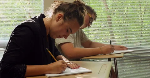 Students doing their school assignments and homework in class. Ultra HD 4K Stock Footage 45573255