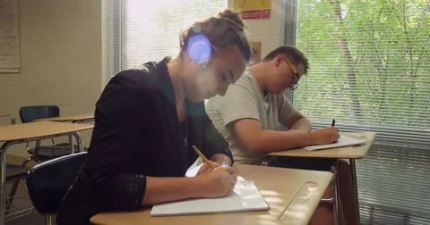 Students doing their school assignments and homework in class. Ultra HD 4K Stock Footage 45621835