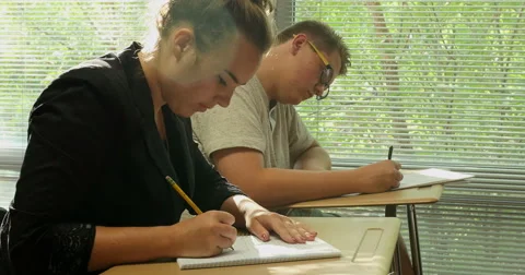 Students doing their school assignments and homework in class. Ultra HD 4K Stock Footage 45647311