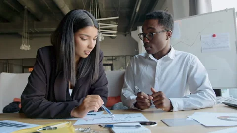 Students engage in a deep analysis of trading charts and financial data within a Stock Footage 335732172