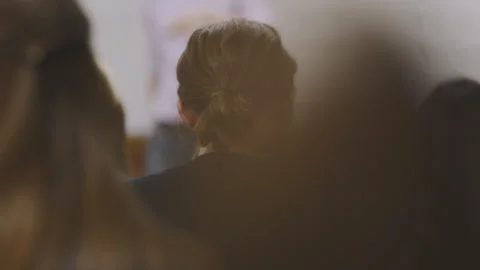 Students engaged in discussion during classroom presentation in study session Stock Footage 310213816