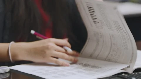Students engaged in group activity discussing worksheet contents Stock Footage 310213045