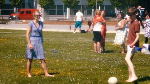 Students enjoy a break from their studies by kicking a soccer ball around 库存影片 109463499