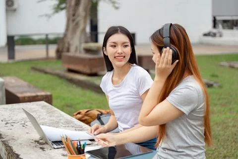 Students enjoying collaborative learning outdoors with technology and music Stock Photos
