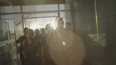 Students Entering Building With Sunset in the Background Stock Footage 233765245