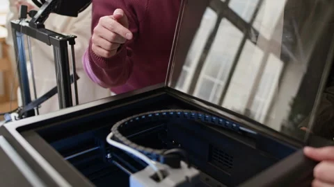 Students Enthusiastically Observing 3D Printing Process with Teacher in Class Stock Footage 335698688