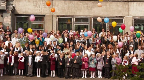 Students of the first class launch balloons in the sky Stock Footage 28652535