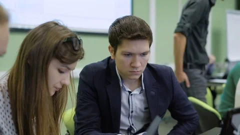 Students focus on solving the problem in the lesson for future financiers. Young Stock Footage 70755080