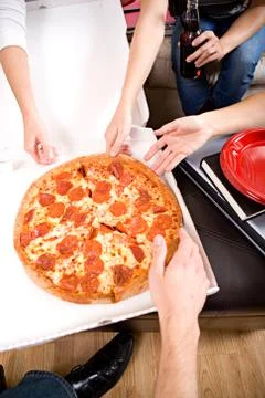 Students: Friends Reaching In To Grab Slice of Pizza Stock Photos
