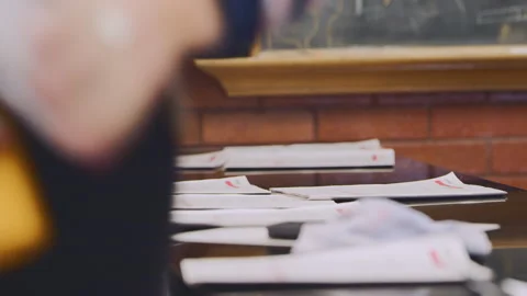 Students gather assignments from classroom table during study session Stock Footage 310212921