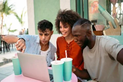 Students gather for a friendly cafe study session, learning together with a.. Stock Photos