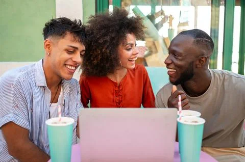 Students gather for a friendly cafe study session, learning together with a.. Stock Photos