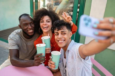 Students gather for a friendly cafe study session, learning together with a.. Stock Photos