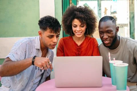 Students gather for a friendly cafe study session, learning together with a.. Stock Photos