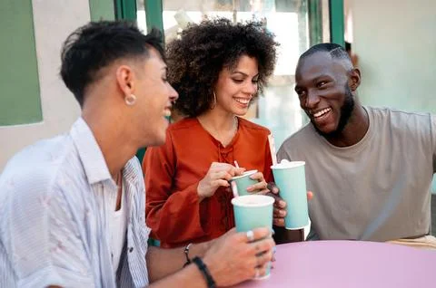 Students gather for a friendly cafe study session, learning together with a.. Stock Photos
