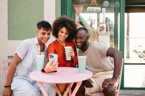 Students gather for a friendly cafe study session, learning together with a.. Stock Photos