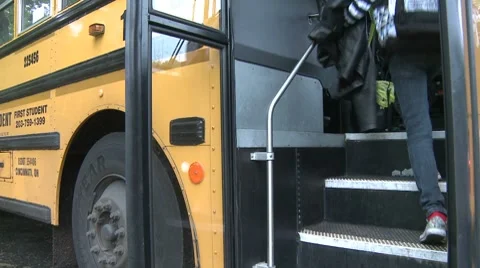 Students getting on bus. (2 of 3) Stock Footage 8696434