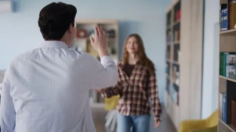 Students giving high five in a library Stock Footage 331866540