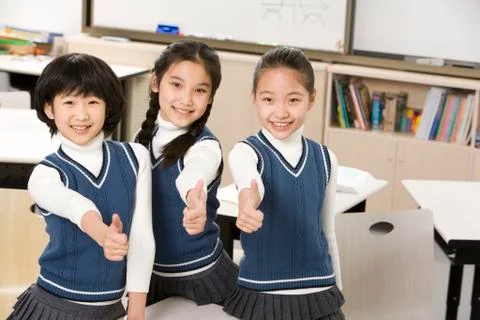 Students giving thumbs-up in the classroom Stock Photos