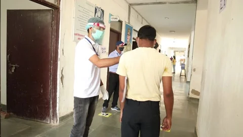 Students going through Temperature check and  at examination center Stock Footage 139379656