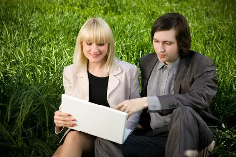 Students on the grass with laptop.. Stock Photos